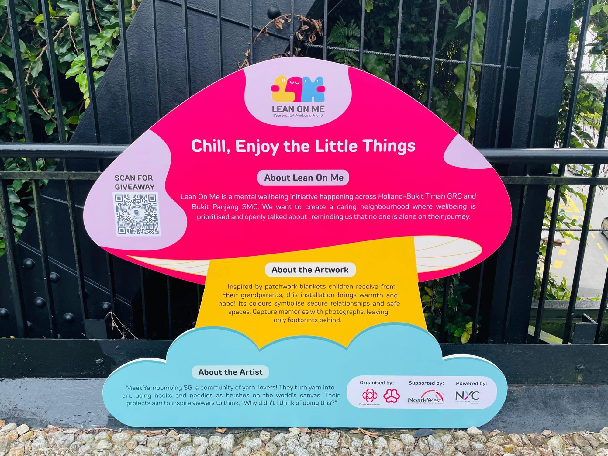 The Lean on Me signboard titled Chill, Enjoy the Little Things at the bridge.